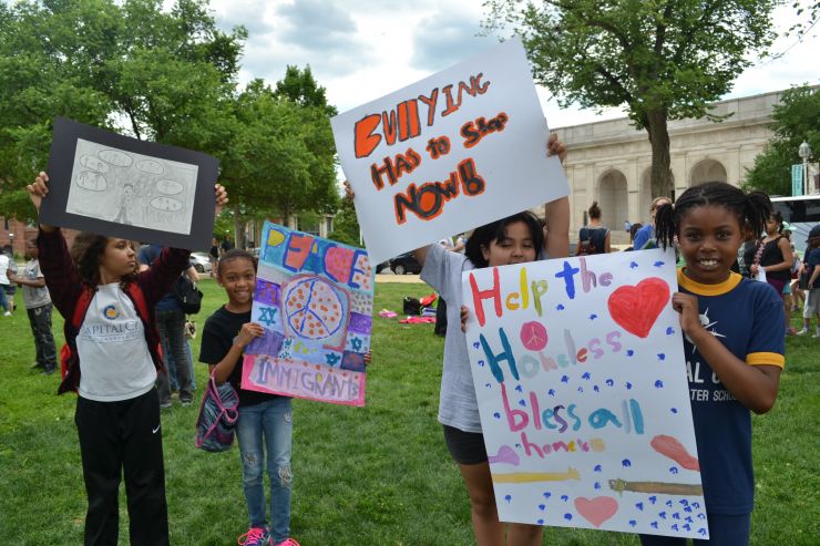 Children holding original protest art